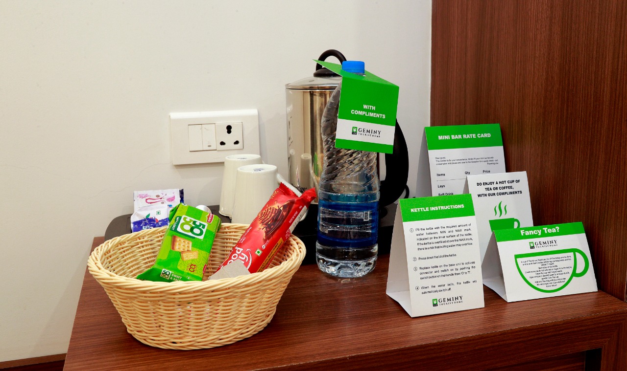In-room tea and coffee station with complimentary mineral water bottles